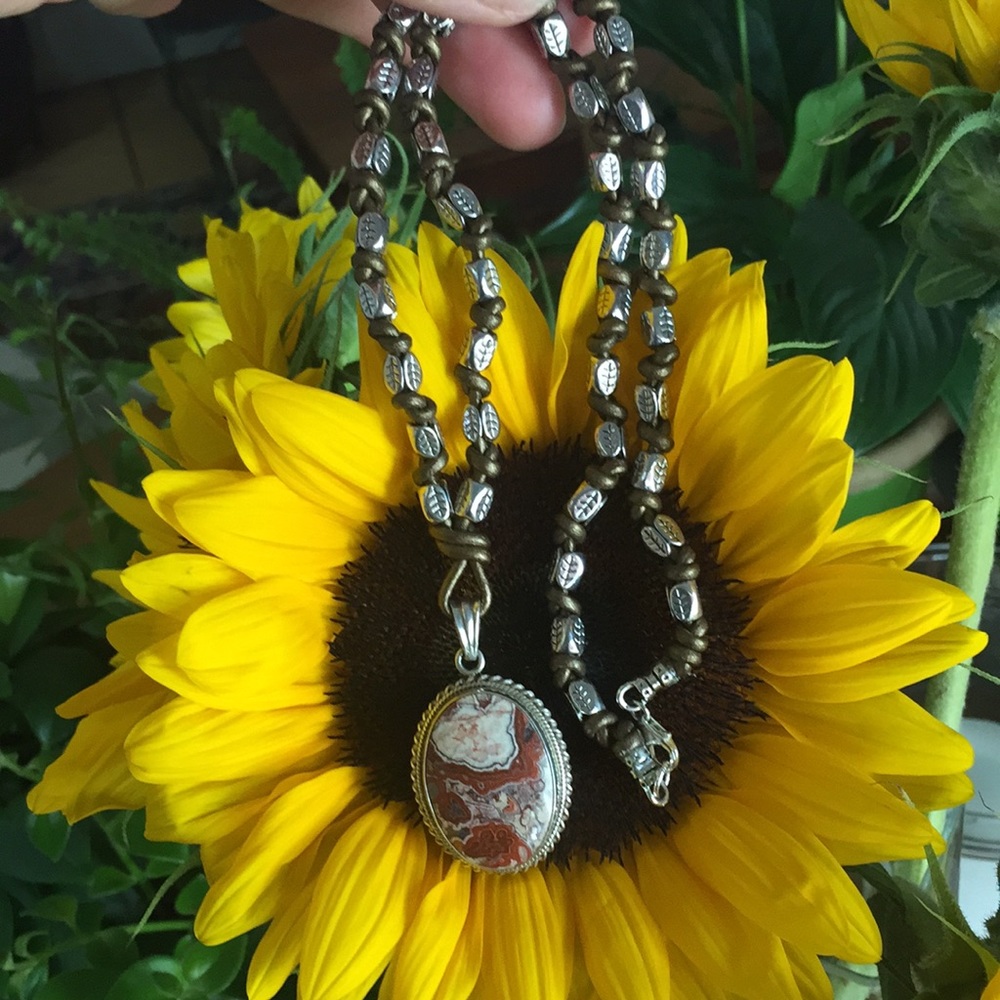 Handmade sterling and leather necklace.